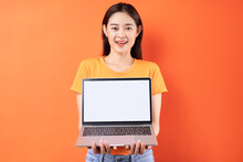 Young Asian Woman Holding Laptop With Empty Screen
