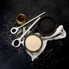 Wall Mural - Black and white sesame seed on black background. Organic food concept