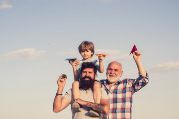 Wall Mural - Happy fathers day. Happy three generations of men have fun and smiling on blue sky background. Grandfather playtime. Airplane ready to fly.