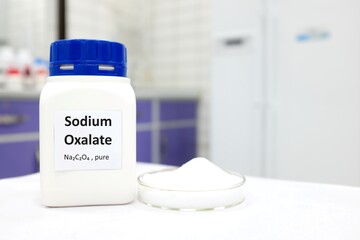 Wall Mural - Selective focus of bottle of pure sodium oxalate toxic chemical beside a petri dish with white solid crystal powder substance. White laboratory background with copy space.