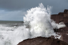 Power Full Ocean Wave Breaks On Rock Shore Line Creating Big Splash Of Water. Storm On West Coast Of Ireland. Power Of Nature Concept.