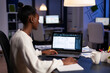 © DC Studio - Black architect using cad softwer to build buildig plan, blue prints. Industrial woman employee studying prototype idea showing cad software on device display.