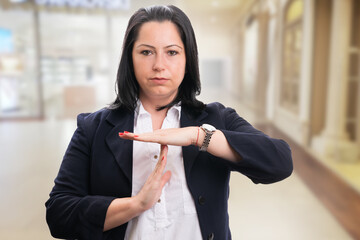 Entrepreneur with serious expression making timeout gesture