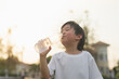 © lalalululala - asian boy drinks water from a bottle outdoors