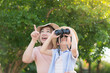 © lalalululala - Asian mother and son using binoculars  outdoors in sunny summer day