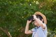 © lalalululala - Cute asian child holding binoculars outdoors in sunny summer day