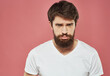 © SHOTPRIME STUDIO - Man with sad face on pink background cropped view of white t-shirt