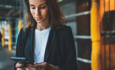 successful businesswoman using app technologies on smartphone during lunch break outside office, Manager uses mobile phone in city outdoors, entrepreneur in suit writes message on cellphone