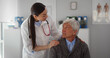 © TommyStockProject - Smiling young female doctor cheering happy senior patient at medical checkup visit