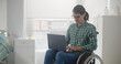 © nimito - Young disabled man using laptop in hospital ward