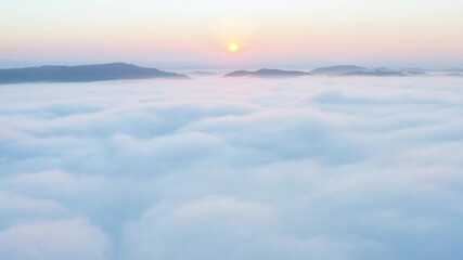 Wall Mural - Aerial view flying in the clouds at sunset. Gold colored sunset cloudiness in high contrast. Real sky. The concept of dreams and weather forecast. Los Angeles during sunrise in beautiful summer day.