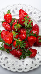 Wall Mural - White plate fill of red strawberries