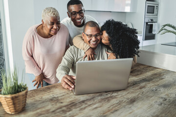 Happy black family doing video call at home - Main focus on son face