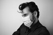 © face_reader_img - Side portrait of a man wearing protective medical mask. Black and white.