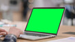 © stockbakers - Female Hands Typing on Laptop with Green Chroma Key Screen