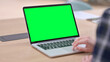 © stockbakers - Female Hands using Laptop with Green Chroma Key Screen