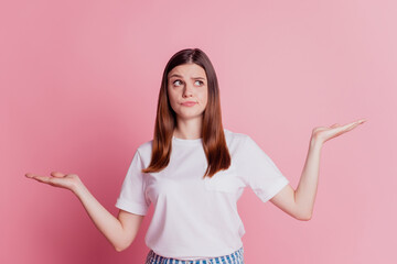 Portrait of beautiful calm young lady presenting empty space hold hands look up