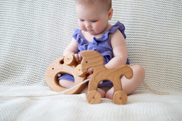 Little cute Baby girl playing with wooden toy