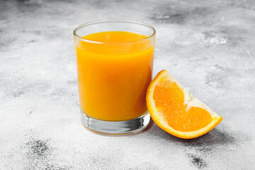 freshly squeezed orange juice in the glass with  orange slice near