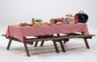Wood table and red napkin cover for outdoor party. White background. Holiday party table. food and drink on table. studio shot.