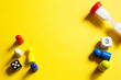 © Ольга Симонова - Layout of board games on a yellow background: dice, chips, hourglass timer. Entertainment at home for children and adults. Copy space