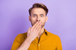 © deagreez - Portrait of attractive embarrassed worried guy closing mouth oops isolated over violet purple color background