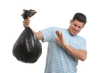 Wall Mural - Man holding full garbage bag on white background