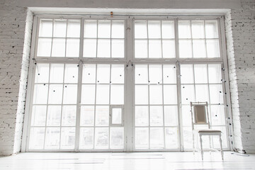 Bright photo studio with big window, high ceiling, white wooden floor