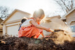 © Inti St. Clair - Happy girl digging in pile of dirt