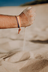 Sticker - Vertical shot of a person playing with the sand at the beach