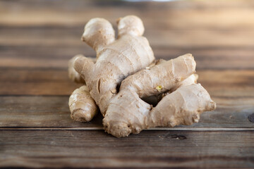 fresh ginger root on rustic wooden board blackground