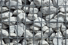 Grey Stones In Gabion  Wall, Baskets, Wire Fence Filled With Stones Background