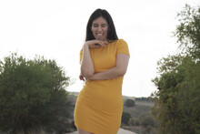 Funny Young Spanish Girl Wearing A Yellow Tight Short Dress Posing Outdoors Showing Her Tongue