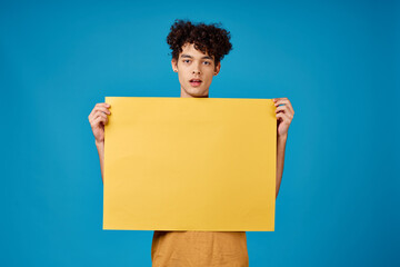 Cheerful guy with yellow phosphorus on a blue background Copy Space