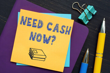 Business concept about NEED CASH NOW? with phrase on the piece of paper.