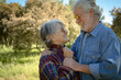 © luciano - Portrait of beautiful senior couple enjoying outdoor excursion in the countryside looking into each other's eyes. Two mature people and nature