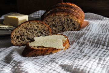 Fresh bread lies on a wooden table.