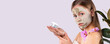 © Viorel - Banner- long format on grey background. Cute woman facial fresh mask. Expressive pointing to the side holding cosmetic product. Present your product. Expression. Cosmetology, beauty, spa. Face care.