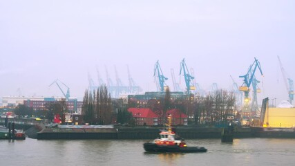 Wall Mural - Hamburg, Germany. Port of Hamburg on the river Elbe in Germany in the morning. Huge industrial cranes with cloudy misty sky