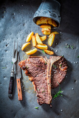 Wall Mural - Tbone steak with salt and herbs. Tbone steak and chips.