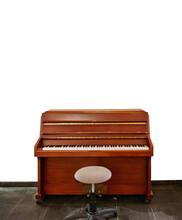 Old Upright Piano And A Stool Isolated On White.