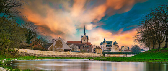 Wall Mural - medieval castle by the river in a small European town