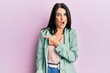 © Krakenimages.com - Middle age brunette woman wearing casual clothes surprised pointing with finger to the side, open mouth amazed expression.