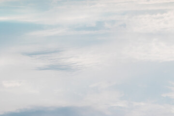 The light cloudy white sky with blue clouds of feathery and cumulus type is processed in light and soft colors. High quality photo