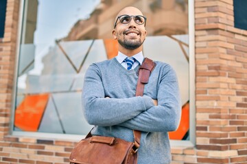 Poster - Young african american businessman smiling happy walking at the city.