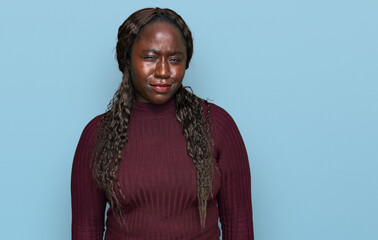 Sticker - Young african woman wearing casual winter sweater skeptic and nervous, frowning upset because of problem. negative person.