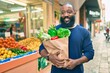 © Krakenimages.com - African american man with beard holding paper bag of groceries from supermarket