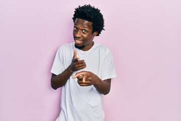 Poster - young african american man wearing casual white t shirt pointing fingers to camera with happy and fu