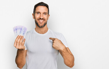 Sticker - Handsome man with beard holding 20 swedish krona banknotes pointing finger to one self smiling happy and proud