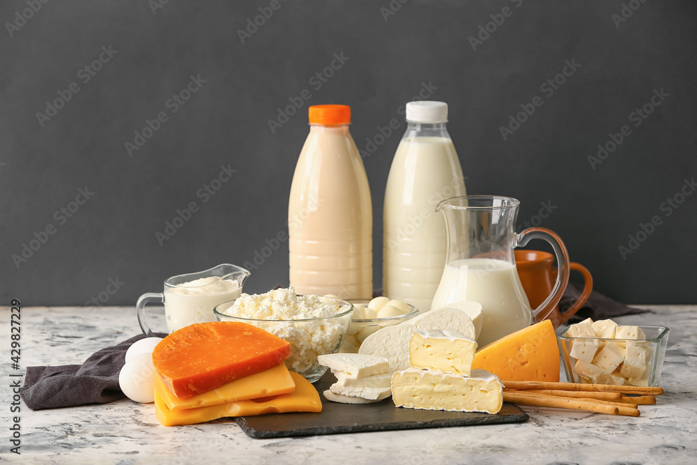 Different dairy products on dark background